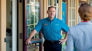 franchisee standing outside greeting a small business owner